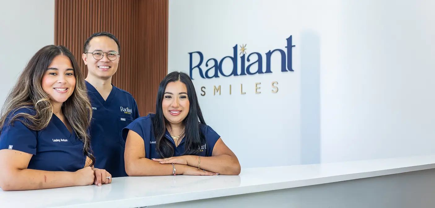 Man and woman laughing together in their living room after visiting dental office in Grand Prairie