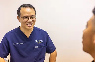 Woman in the dental chair listening to her dentist