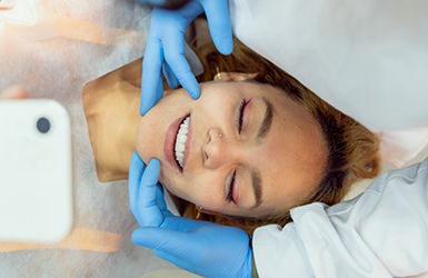 Dental patient looking at her new smile after cosmetic dentistry