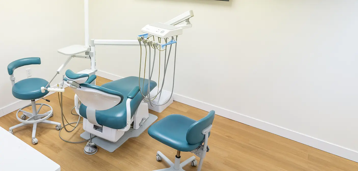 Row of dental instruments next to a treatment chair
