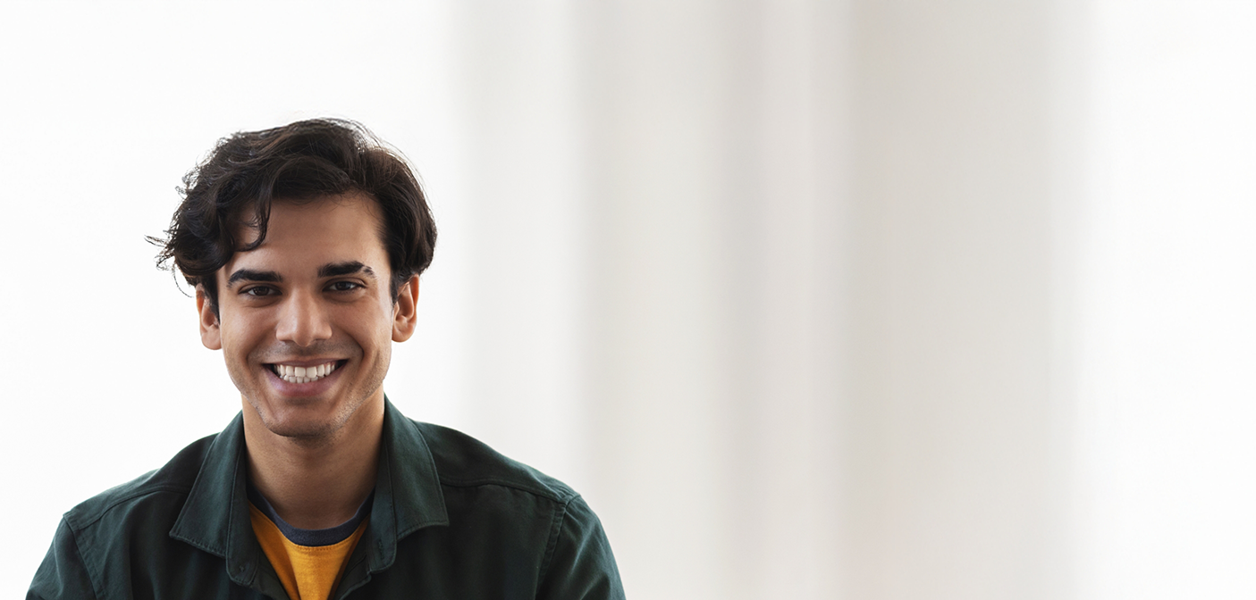 Young man grinning after gum disease treatment in Grand Prairie