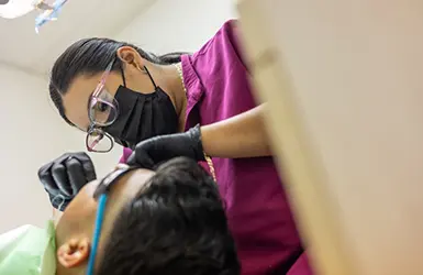 Woman grinning at her dentist during a dental checkup