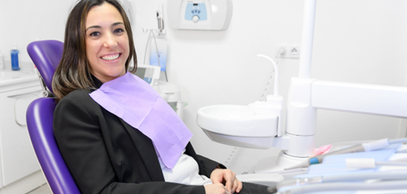Woman sitting in dental chair smiling