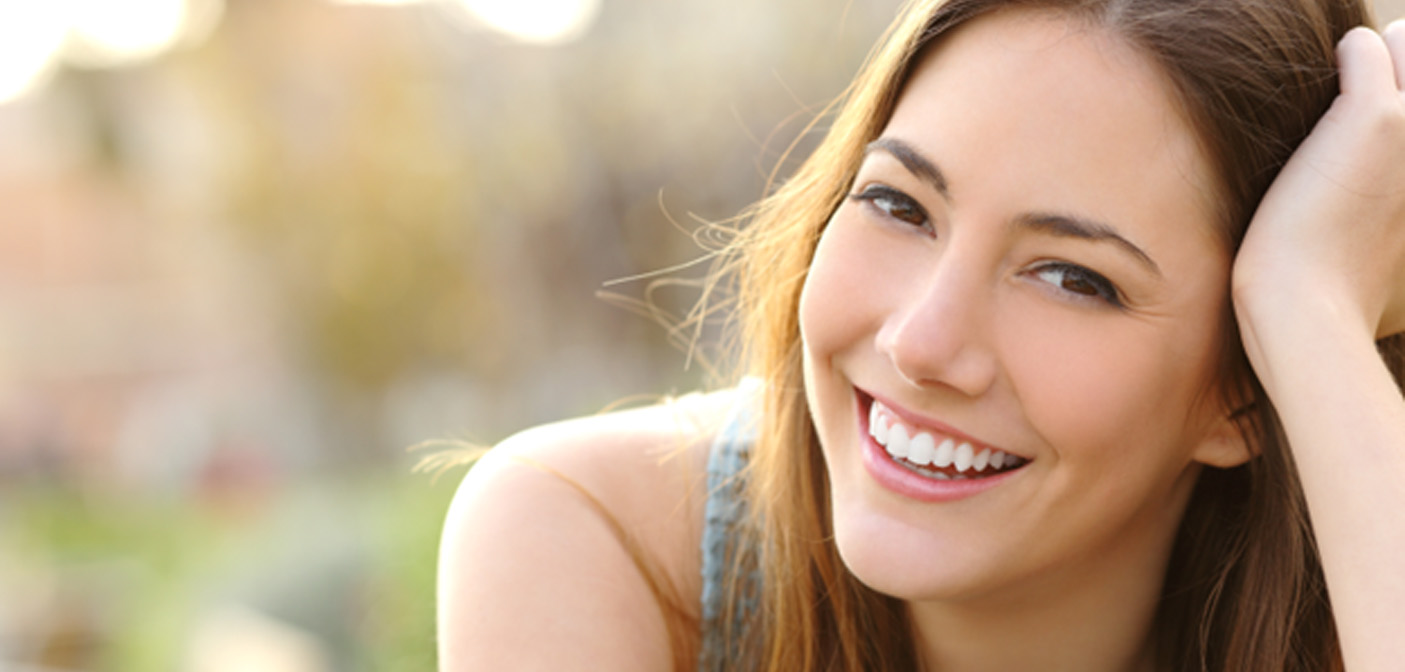 Close-up of woman smiling outside