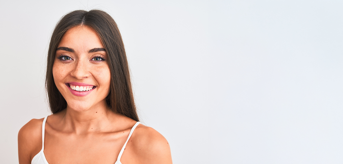 Young brunette woman smiling after wisdom tooth extractions in Grand Prairie